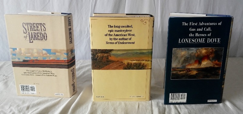 lot 26 image: (3) Larry McMurtry 1st. Edition Hard Cover Books Lonesome Dove, Sequel-Streets of Laredo & Sequel-Dead Mans Walk