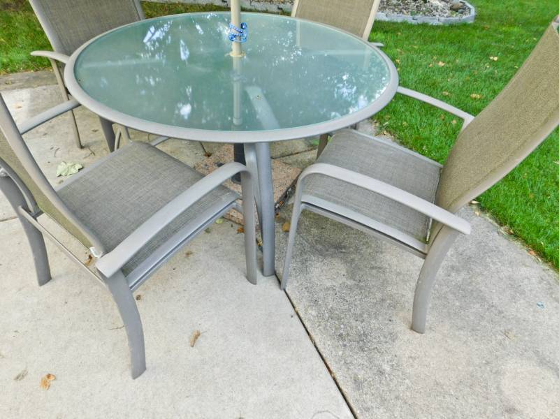 lot 101 image: patio table, 4 chairs, umbrella and cast iron base