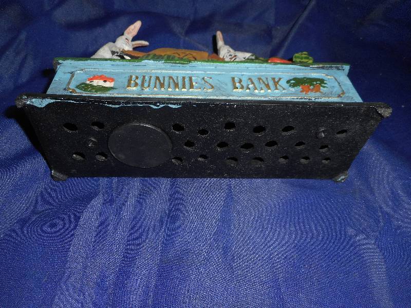 lot 1 image: CAST IRON BUNNIES COIN BANK