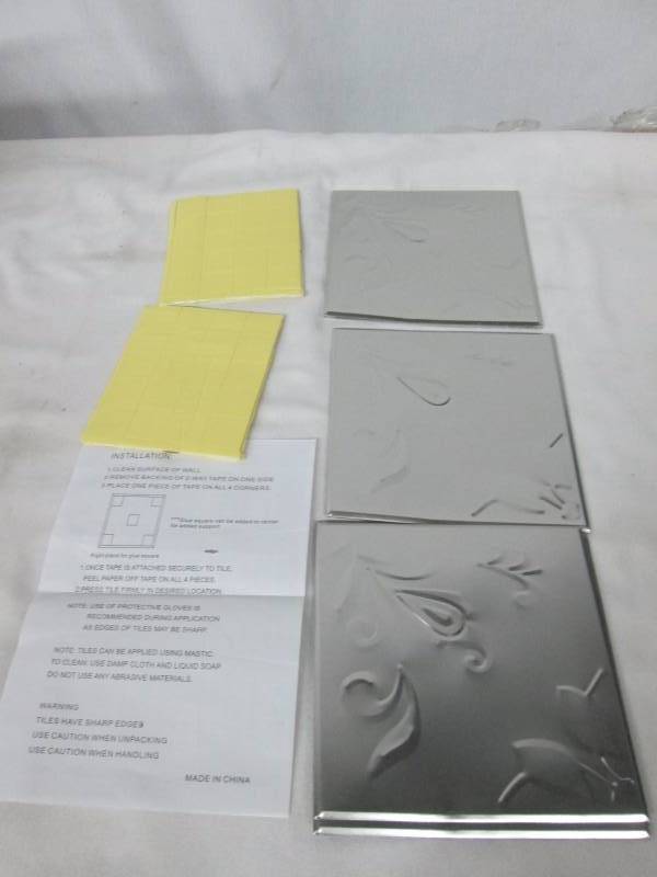 lot 73 image: Embossed Silver Metal Wall Tiles Set of 16