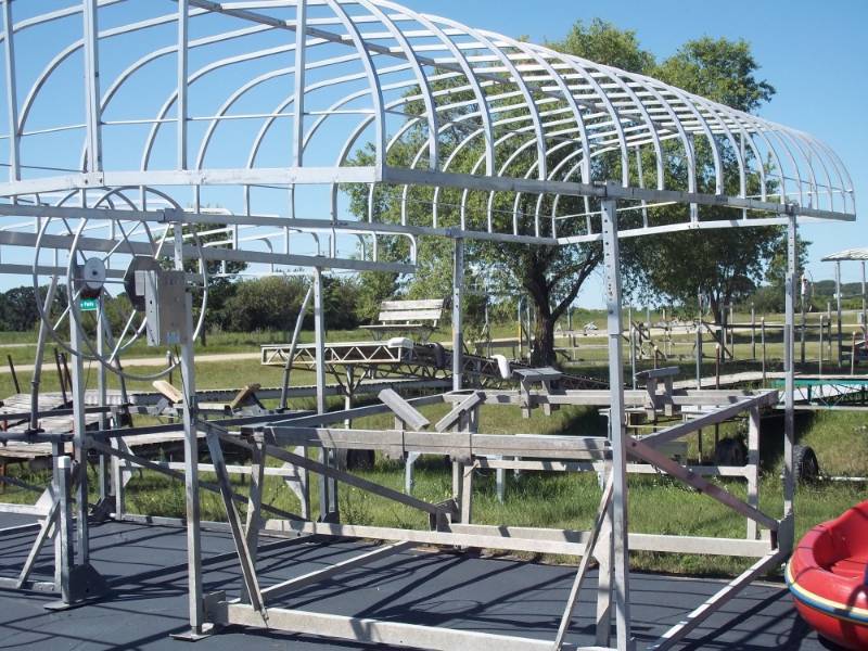 lot 69 image: Vibo Boat lift 96 wide with Blue Canopy22.  Canopy has a few rips