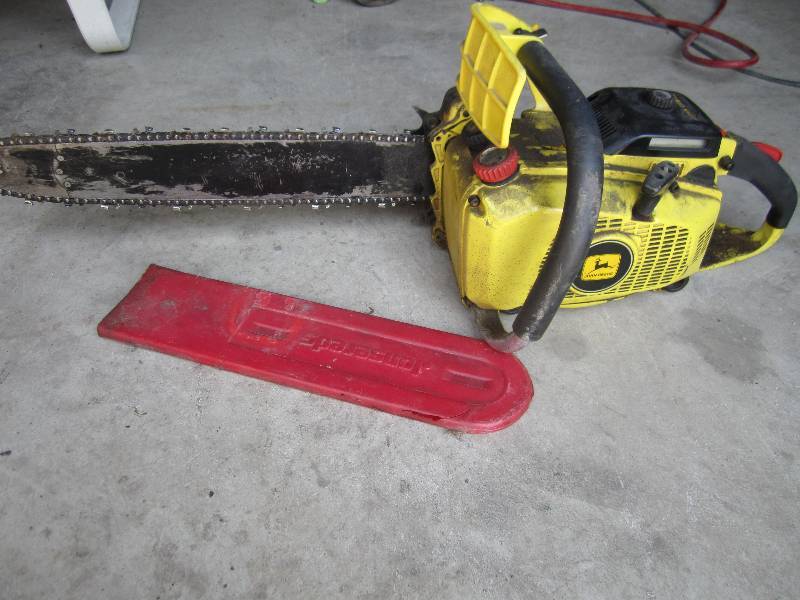 lot 47 image: John Deere chain saw...