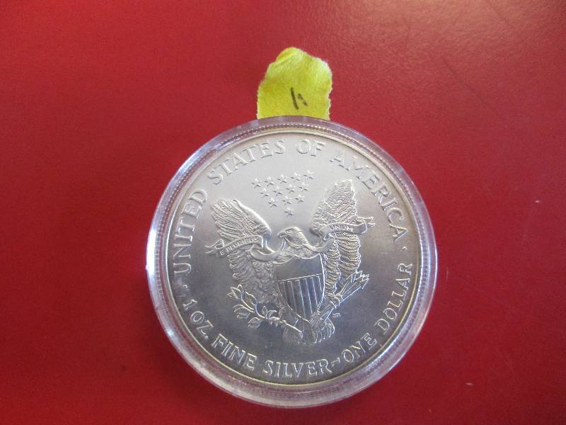 11. 2002 American Silver Eagle 1oz bullion coin in a protective capsule.