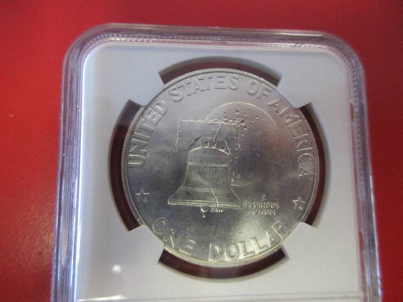 23. 1776-1976 Eisenhower 40% silver dollar certified by NGC in Mint State Condition. The signature Bell and Moon reverse celebrates the 200th anniversary of the United States.  Beautiful coin