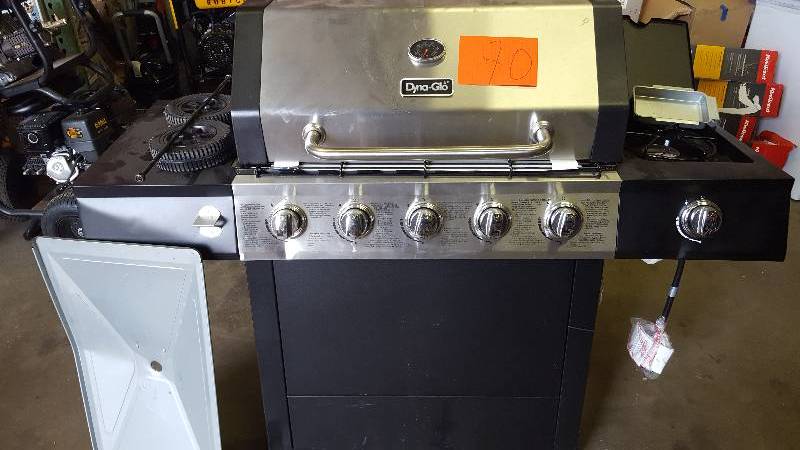 lot 70 image: Dyna- Glo 5-Burner Open Cart LP Gas Grill - New damage on leg- few scratches see pictures
