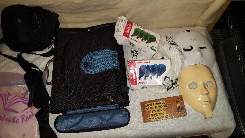 lot 67 image: Computer bag, wrapping paper, accordian folder, masks, colored light bulbs, water mattress, miraca.