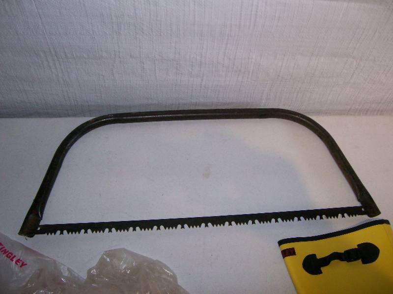 lot 11 image: Tingley boots & bow saw