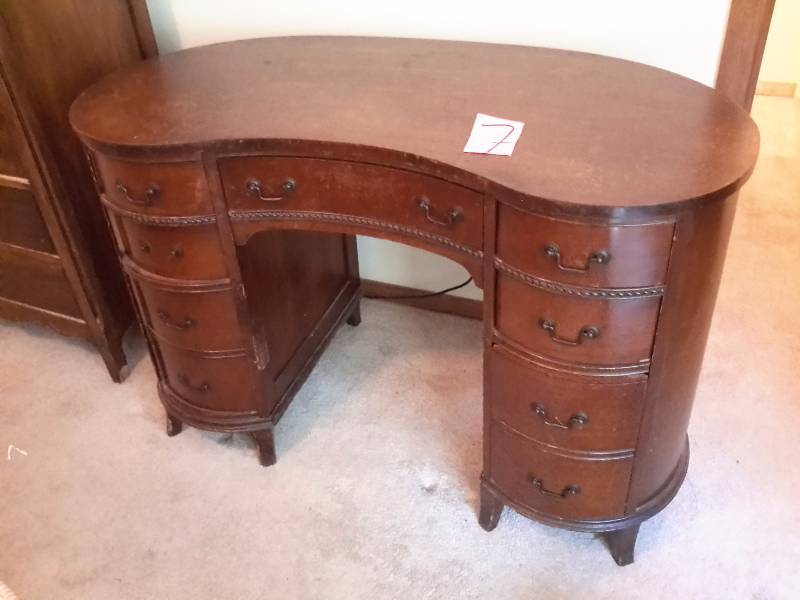 lot 7 image: Kidney shaped desk.  7 drawers.. Looks like Walnut wood