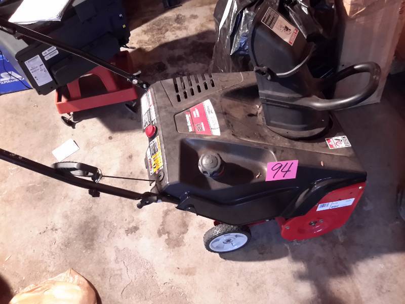 lot 94 image: Yard Master, 21 in Snow Blower.. Turns over, but looks like the back side guard is missing.. Chute is loose, but included.. This doesnt look like it has been used much.. Could be a good unit for someone that is handy