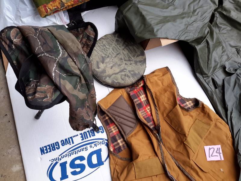 lot 124 image: Hunting Vest, Rain Suit (pants are ripped right below waist), Camo Seat, Camo folding chair.