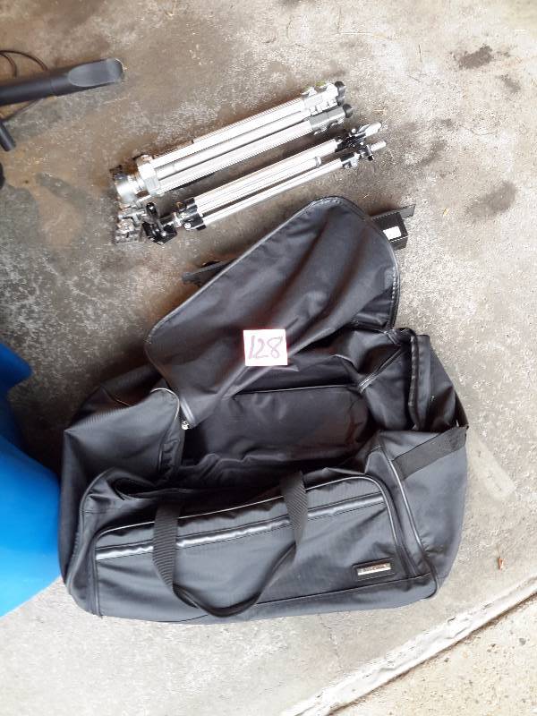 lot 128 image: 2 Tripods, Roller Bag (one wheel is broken out of bottom.. Either repair or use without it.. Nice duffle otherwise), Power Strip