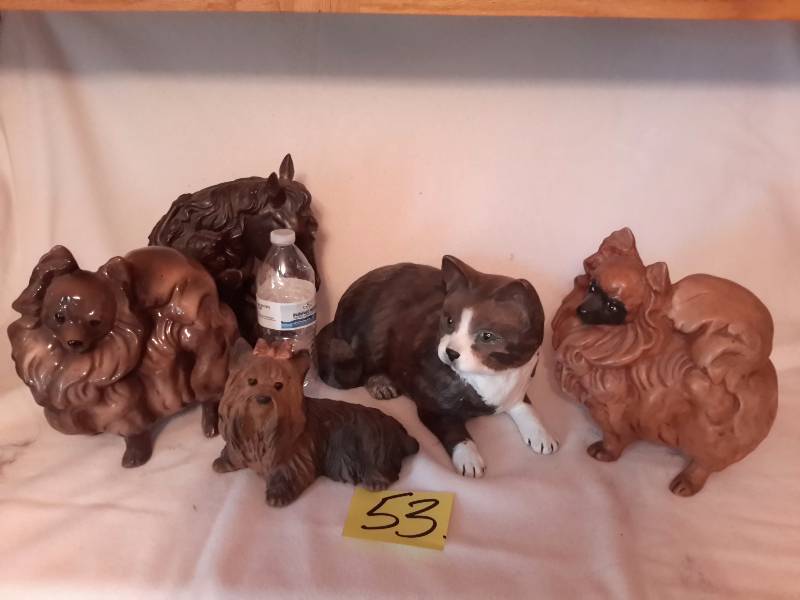 lot 53 image: Plaster Cast Dog Statues.. See water bottle for size perspective
