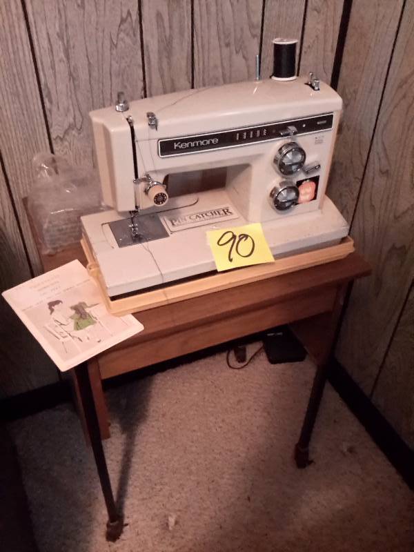 lot 90 image: Kenmore Portable sewing machine plus LOTS of bobbins with thread.  Untested, but looks to be in good shape. Sewing stand included