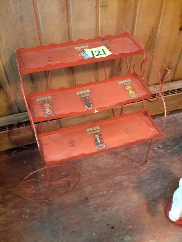 lot 121 image: Nice metal shelf.. Like a cart.. Shelves are approx 18 in w. 3 Shelves