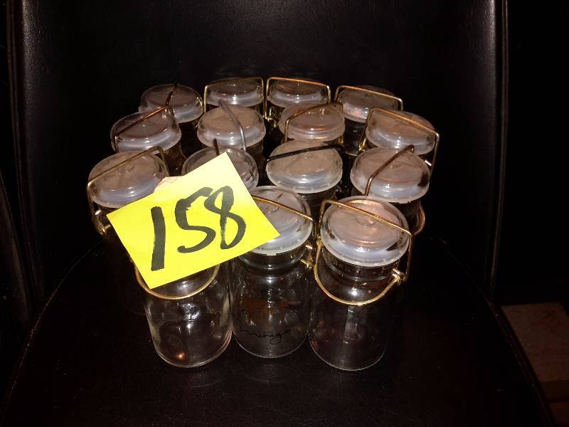 lot 158 image: 15 small, glass storage bottles.  Mirage Logod.    I would say hold about 2 cups.