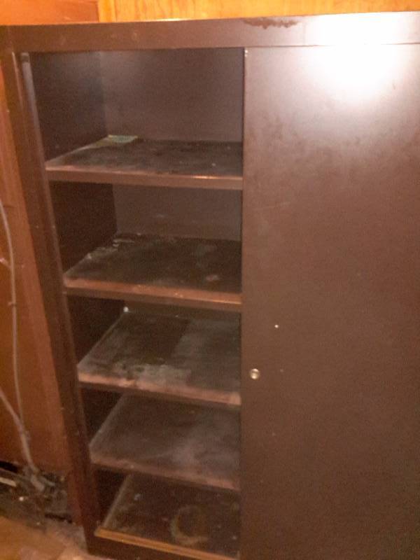 lot 163 image: Nice Brown Metal Storage cabinet with sliding doors.. 42 in w x 25in d x 62 in h.  BRING YOUR OWN LOADING HELP.. Right by the basement walk out door.