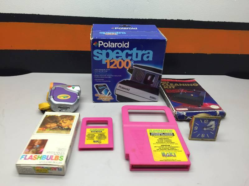 lot 22 image: POLAROID SPECTRA 1200 I CAMERA, NINTENDO CASES (14), MEMOREX CDS LARGE REMOTE,NINTENDO SYSTEM CLEANER