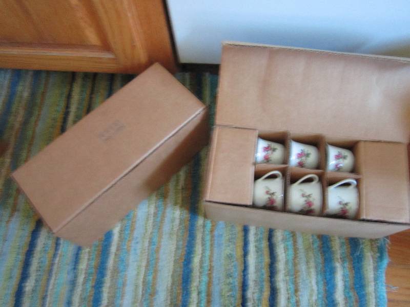 2 sets of floral tea cups and match...