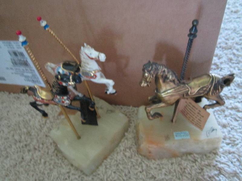 2 carouselle horses with stone base...