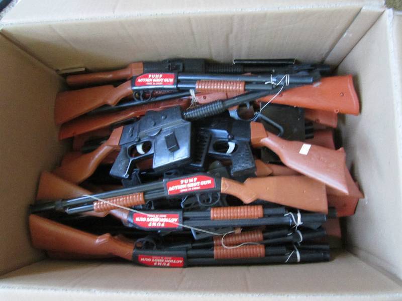 Box of toy pump air shoot guns...