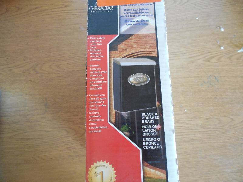 Designer Black Vertical Wall-Mount Locking Mailbox with Brushed Brass Decorative Emblem and Lid