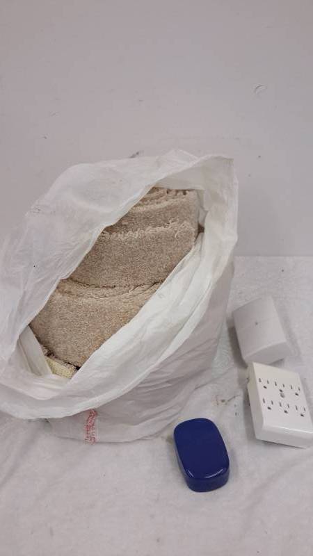 Bag of carpet strips, electrical splitters, blue case