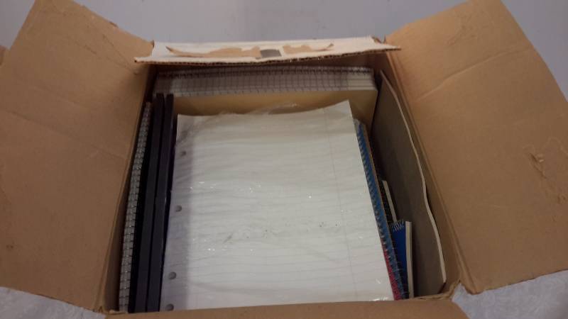 Box of notebooks, paper, and tablets