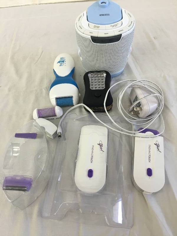 lot 29 image: two yes shavers ,pedi egg,homedics sound machine,flashlight