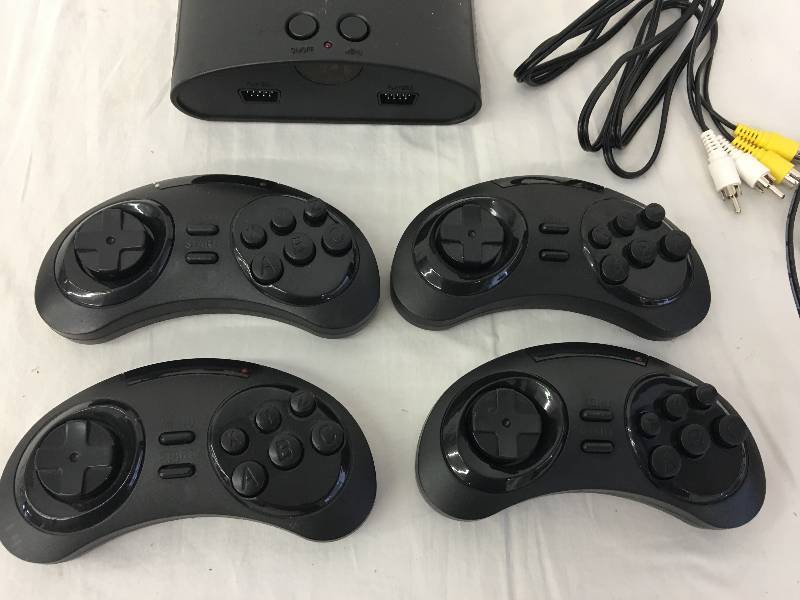 lot 103 image: Sega Genesis and 4 controllers
