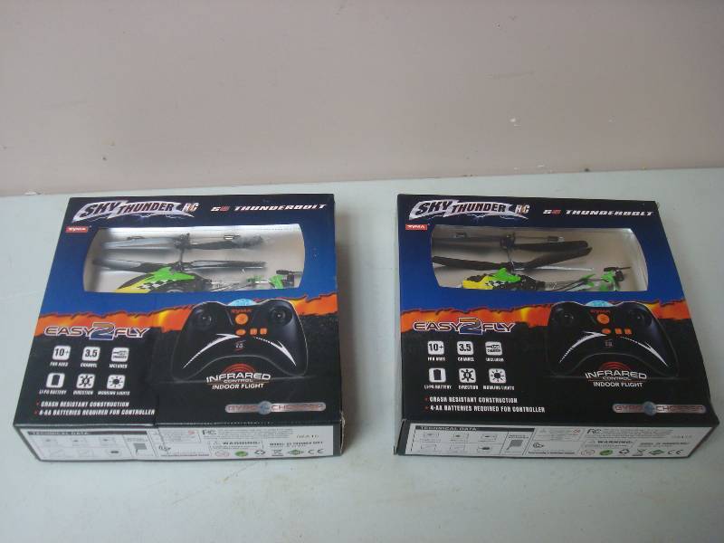 lot 28 image: Pair Of Sky Thunder RC Helicopters, New, Looks Like Some Damage To Helicopter, Green