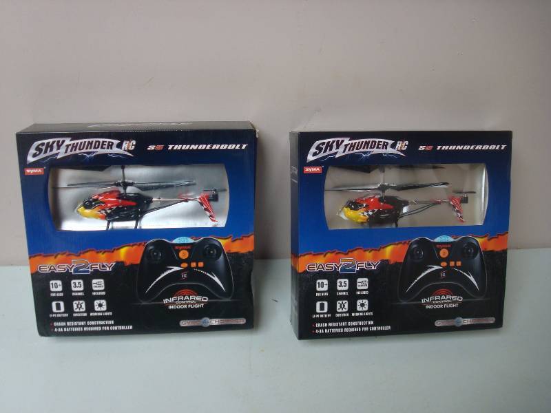 lot 29 image: Pair Of Sky Thunder RC Helicopters, New, Looks Like Some Damage To Helicopter, Red