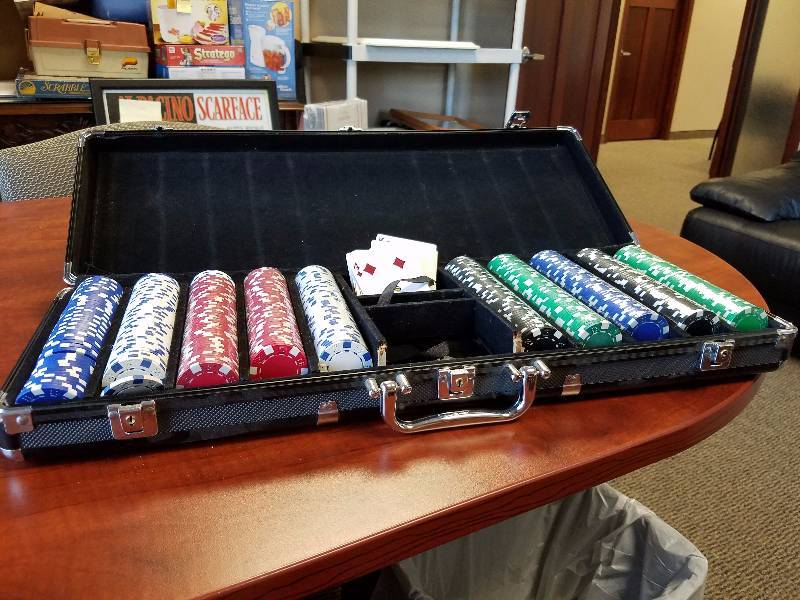 lot 33 image: Poker Chip with playing card and a key to lock up the case