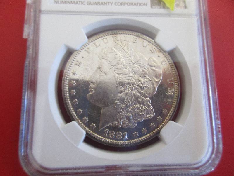 2. 1881-S Morgan Silver Dollar NGC Certified in Mint State MS63 condition. Very nice coin, the case has crack on the side but is still sealed