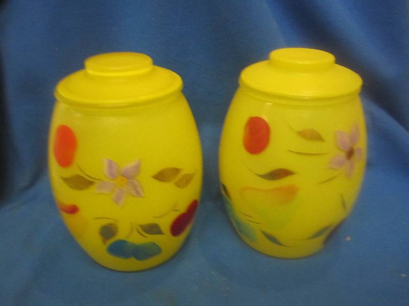 2 bright yellow jars with floral d