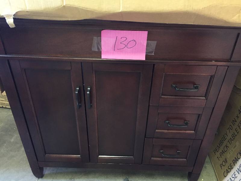 lot 130 image: Foremost Ashburn 36 in. W x 21.625 in. D x 34 in. H Vanity Cabinet Only in Mahogany slight damage on one corner see picture