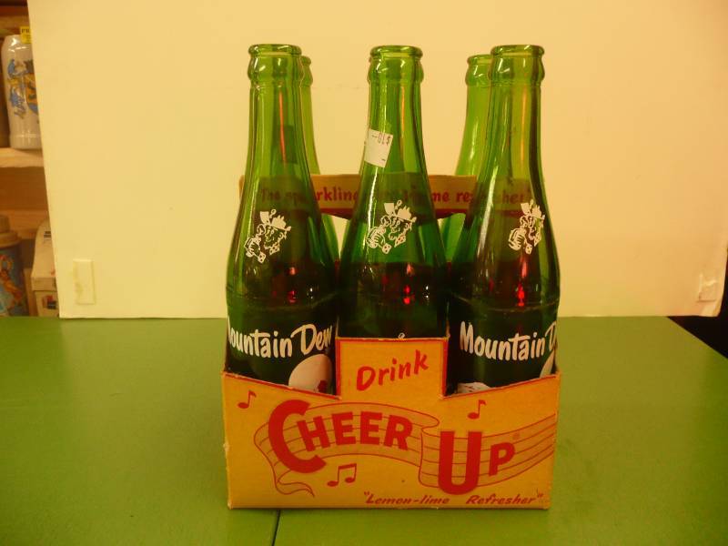 6 PACK VINTAGE MOUNTAIN DEW BOTTLES IN A VINTAGE CHEER UP 6 PACK HOLDER