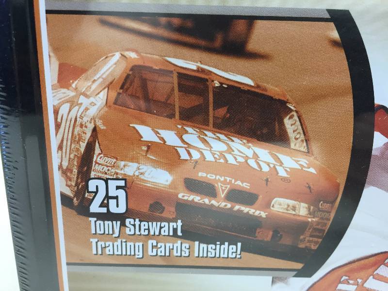 lot 26 image: TONY STEWART BEAR BANK, NASCAR LUNCH BOX, TRIBUTES TRADING CARDS INSIDE, HOME DEPOT GLASS MUG