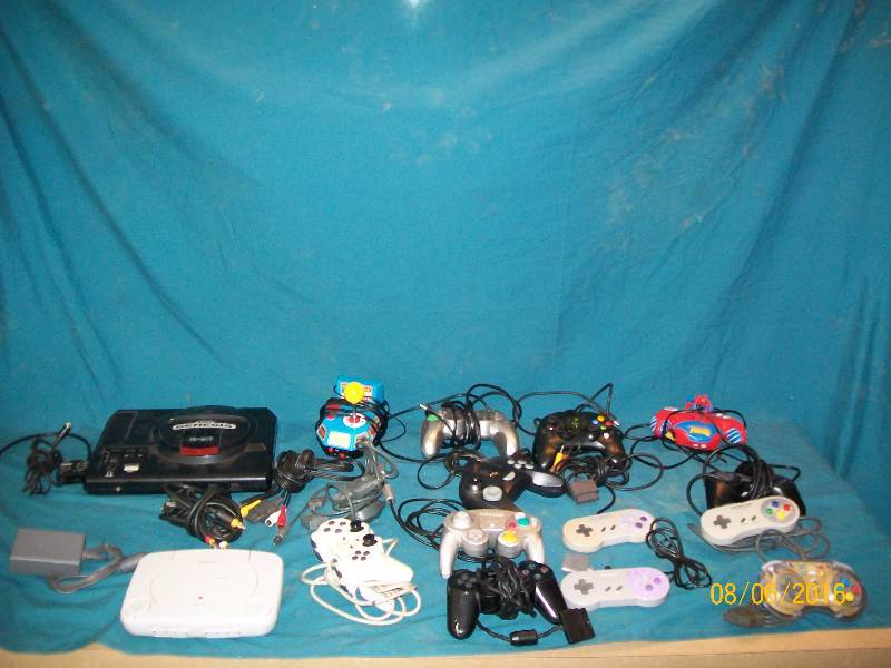 lot 7 image: Assorted Video Gaming Controllers & Cables Includes A PS1 Console with power cord & Controller