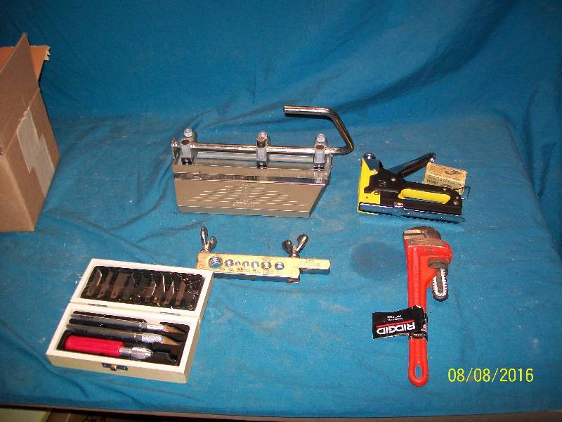 lot 64 image: 3 Hole Punch & Flaring Tool & Staple Gun & Exacto Knife Set & Ridgid Pipe Wrench. See Pictures
