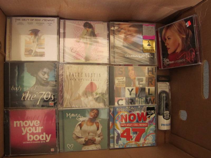 lot 63 image: Box of new CDs and earphones...