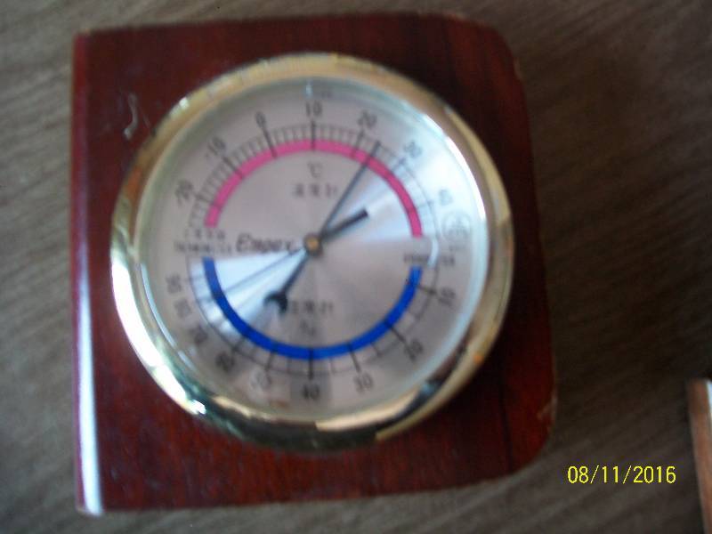 lot 25 image: Mantel Empex Thermometer & Hygrometer in wooden casing.