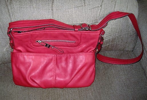 lot 31 image: Tyler Rodan Red Purse. Approximately 8 tall 12 wide with adjustable shoulder strap.