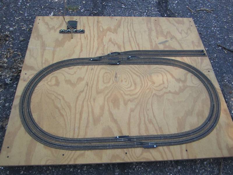 Model train track mounted on plywoo...