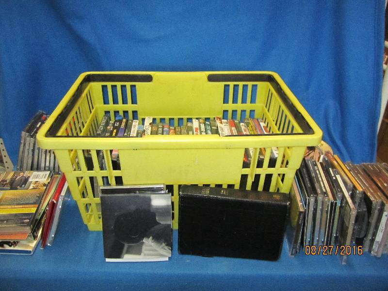 Large lot of CDs and DVDs in plasti...