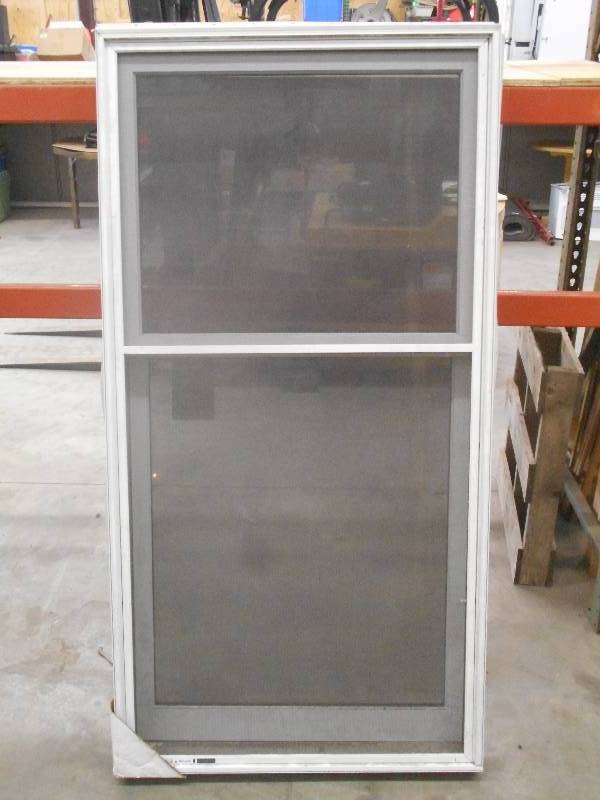 lot 86 image: Unused Marvin 35.5x68.5 Sliding W...