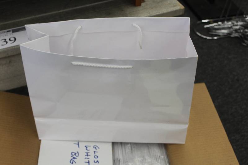 lot 40 image: Box Lot of Gloss White Gift Bags