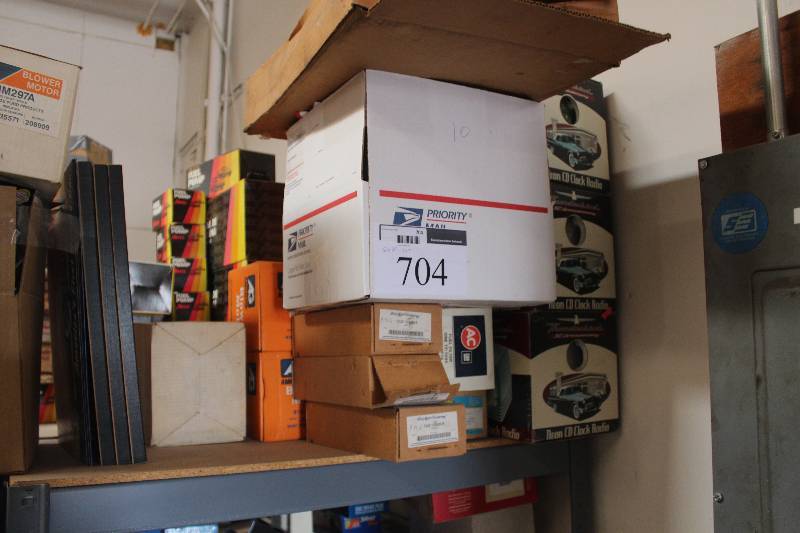 lot 704 image: Shelf Lot of Neon CD Clock Radio, AC Fuel Filter, Corvette Memorabilia, Ford Parts New In Box Includes F2UZ-1522405-B,