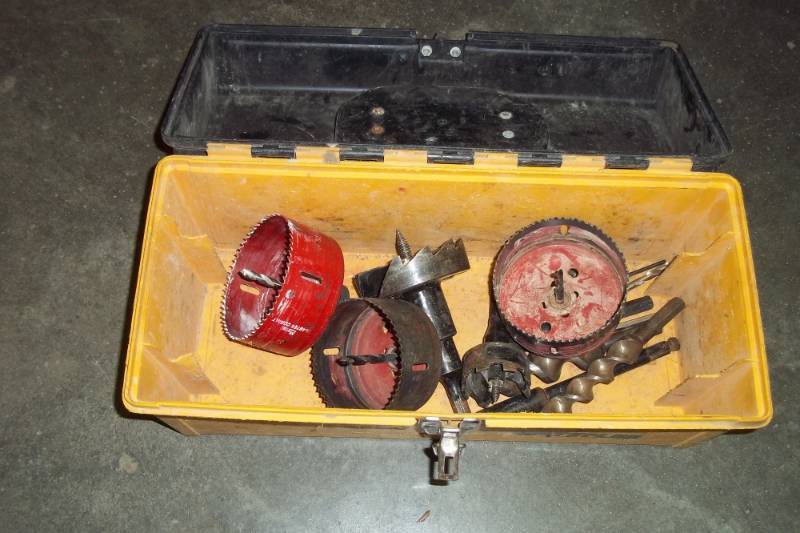 lot 39 image: Yellow Tool Box with drill bits and hole saws