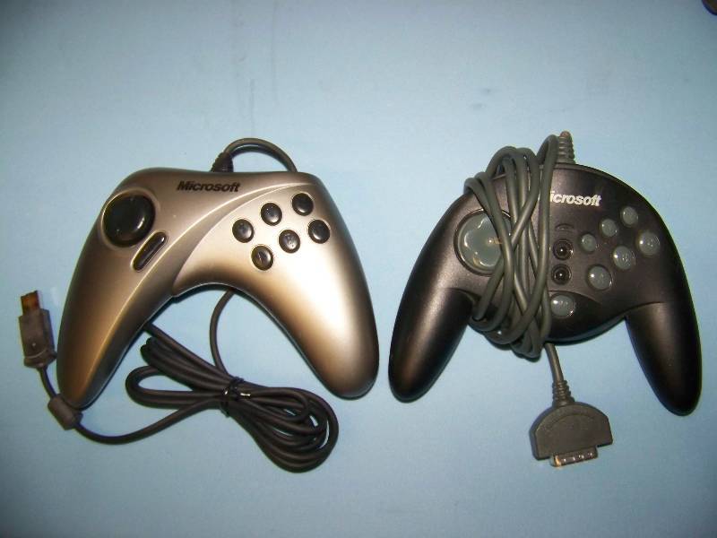 lot 65 image: (4) Microsoft and (1) Logitech, Video Game  PC Game Controllers