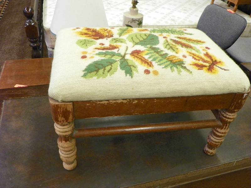 Footstool with leaf motif, wear on legs
